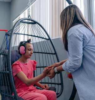 child sitting with teacher